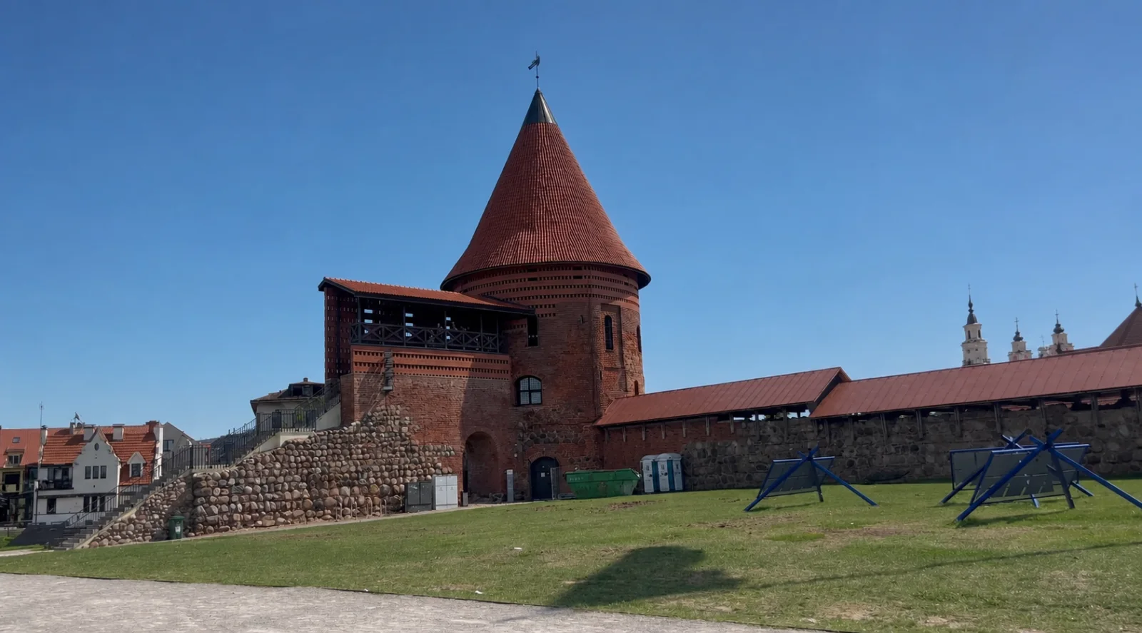 Kaunas Castle tower and defensive wall under a clear blue sky